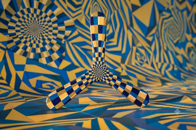 Three-blade Modern boomerang with blue and yellow checkerboard op-art design against a bold geometric graphic background