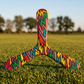 Boomerang tripale Watt motif éclair multicolore posé sur herbe